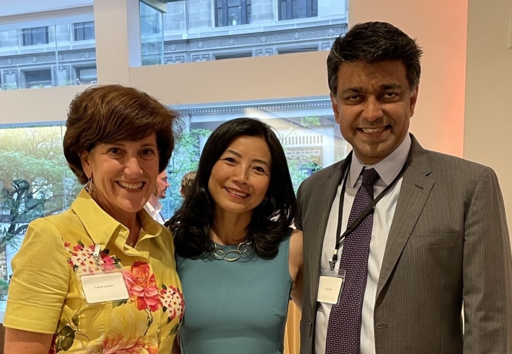 Social Finance's Laura Lauder and Tracy Palandjian and Rockefeller Foundation's Zia Khan pose for a photo at an impact investing event in New York.